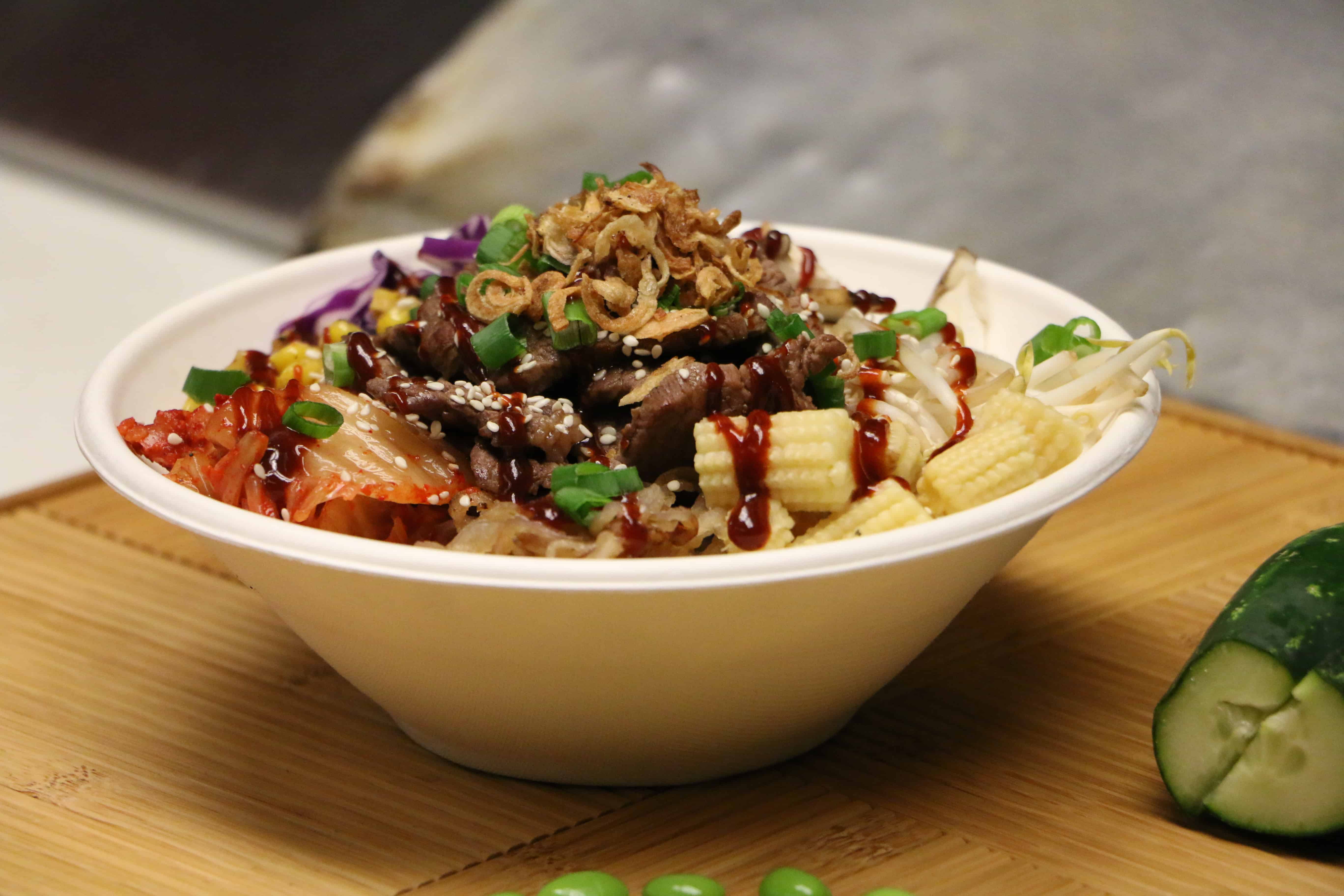 white bowl with kimchi korean beef onions and vegetables